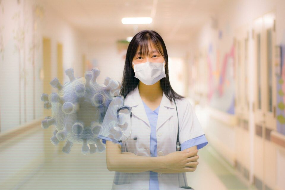 Asiatische Frau mit Mundschutz in einer Klinik