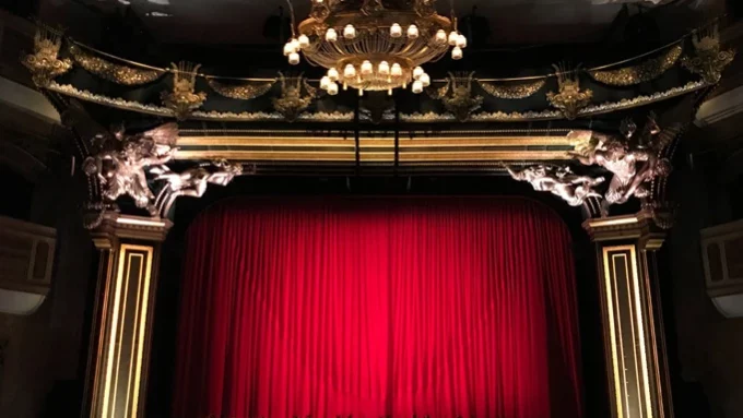 Blick auf eine Theaterbühne mit geschlossenem Vorhang