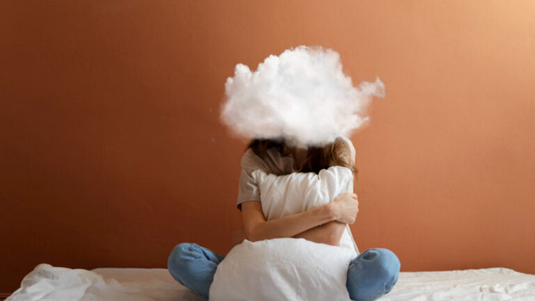 person auf dem bett sitzend, wolke über dem kopf